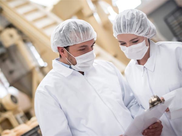 MAXCLEAN production specialists reviewing quality documentation